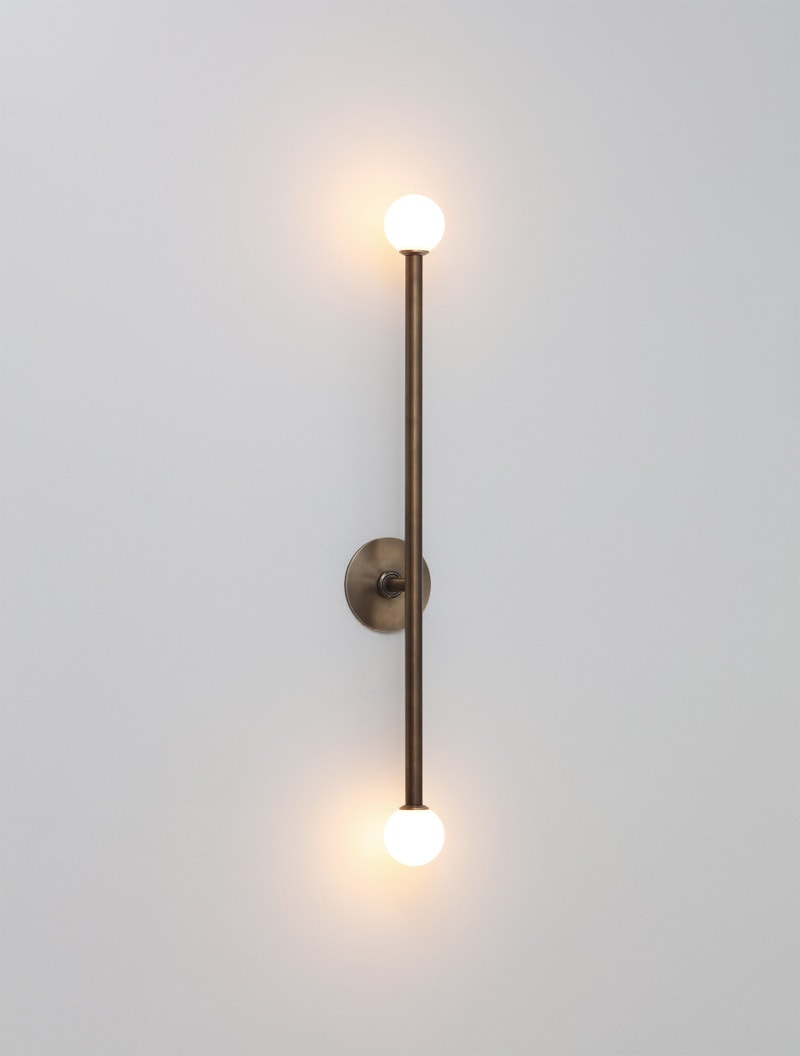 Brass T2 Sconce shown in Bronze, and Matte White Globes